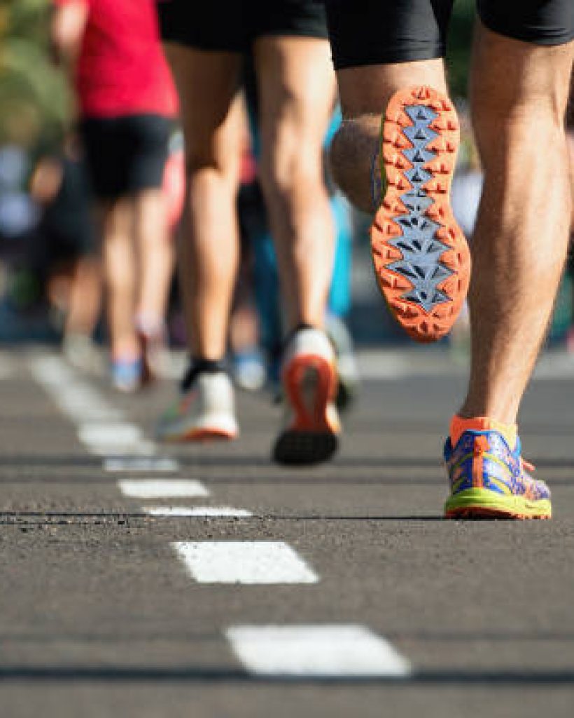 Marathon running race, people feet on city road
